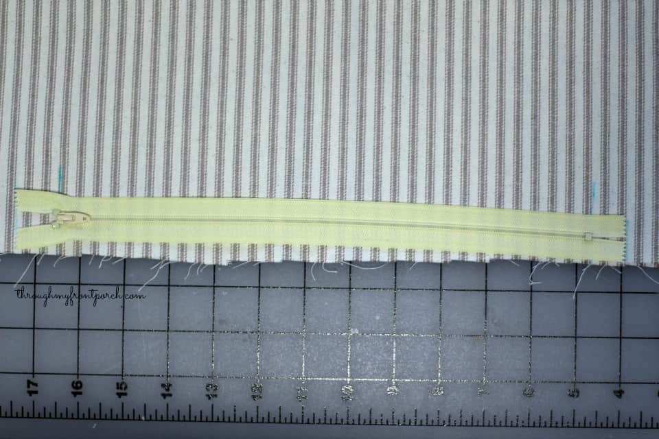 Zipper on top of fabric.