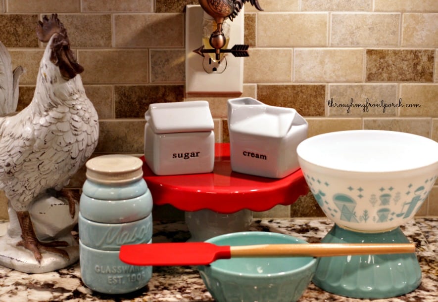 Rooster and kitchen decor on a counter top.