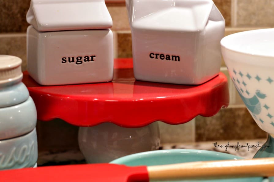 Sugar and cream figurines on a cake stand.