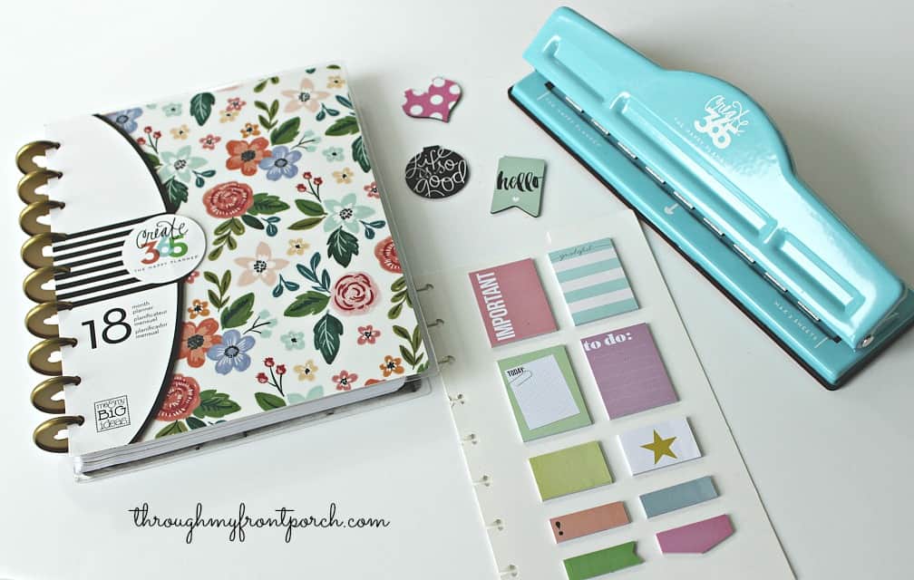Happy Planner with hole punch and stickers.