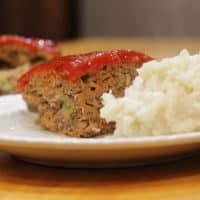 Meatloaf with mashed potatoes on a plate.