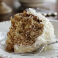 A slice of coconut pecan bundt cake on plate.
