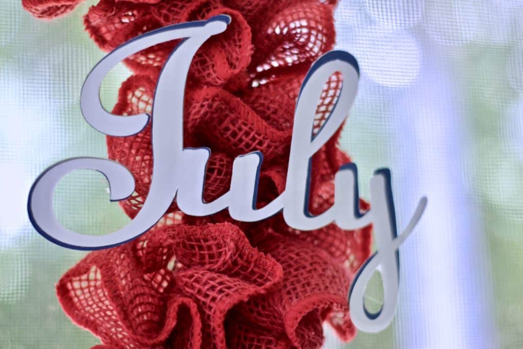 The July word die cut glued to the ribbon.