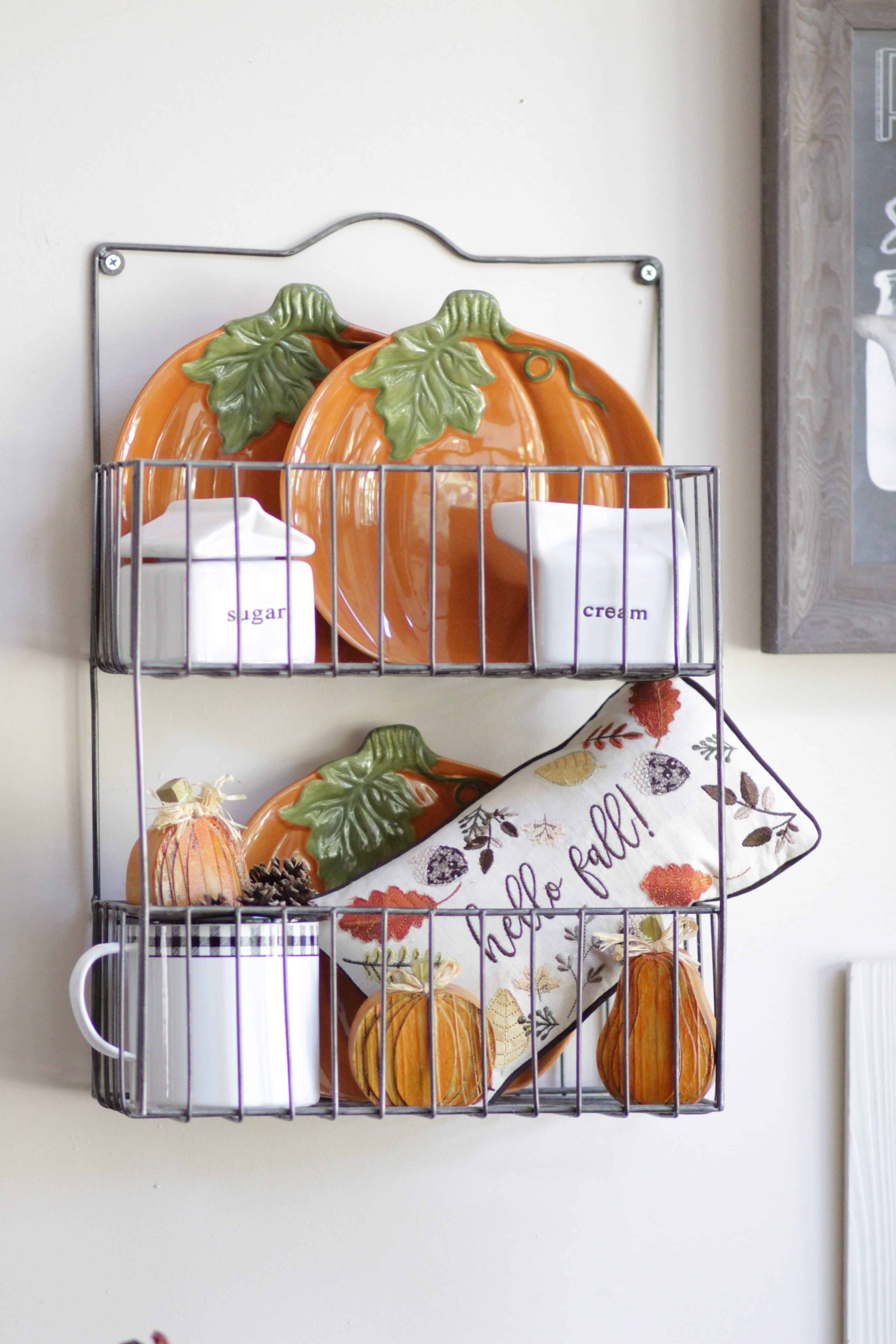 A wall basket filled with fall decor.