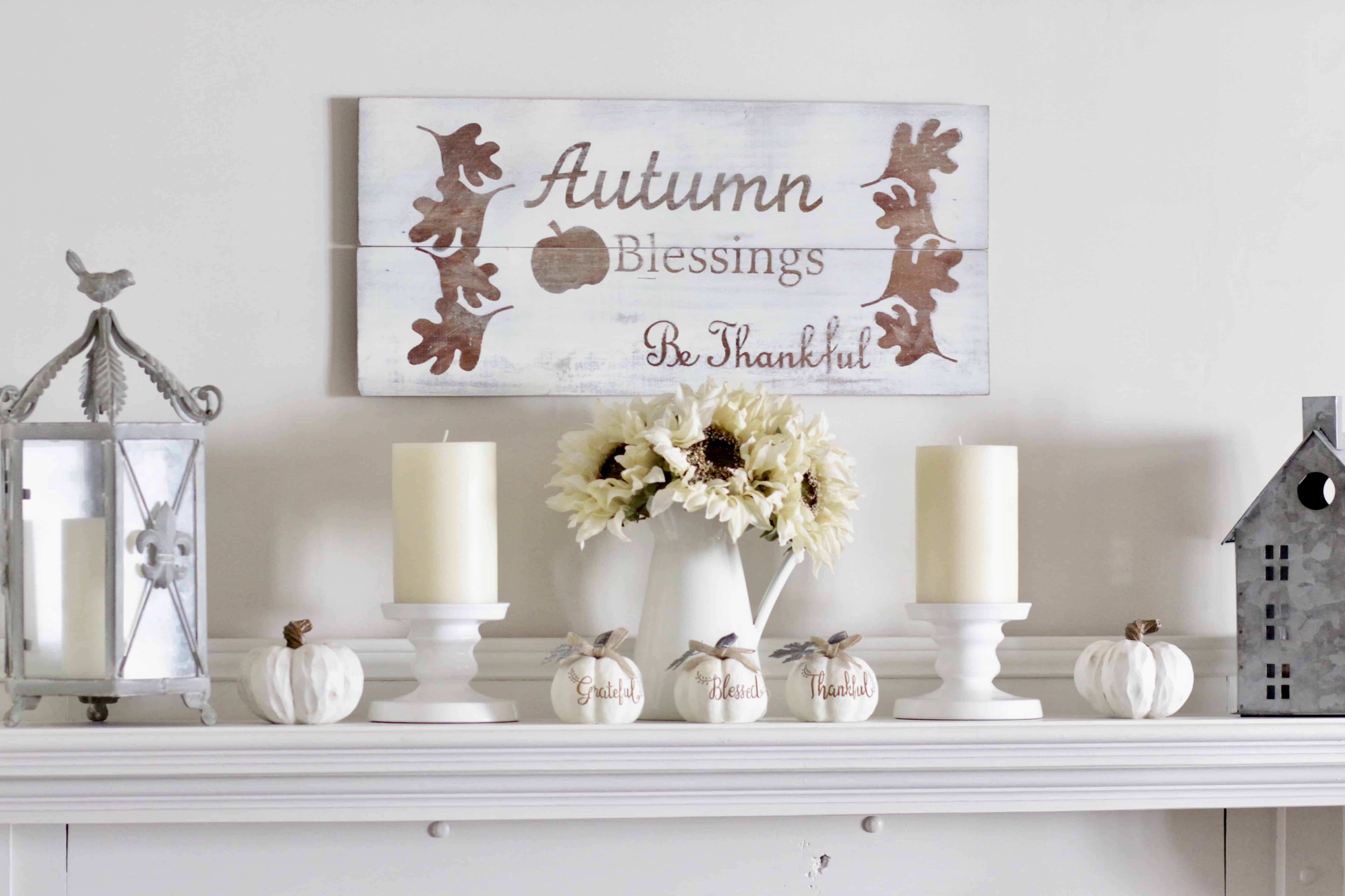 A fall mantel with sunflowers and candles.