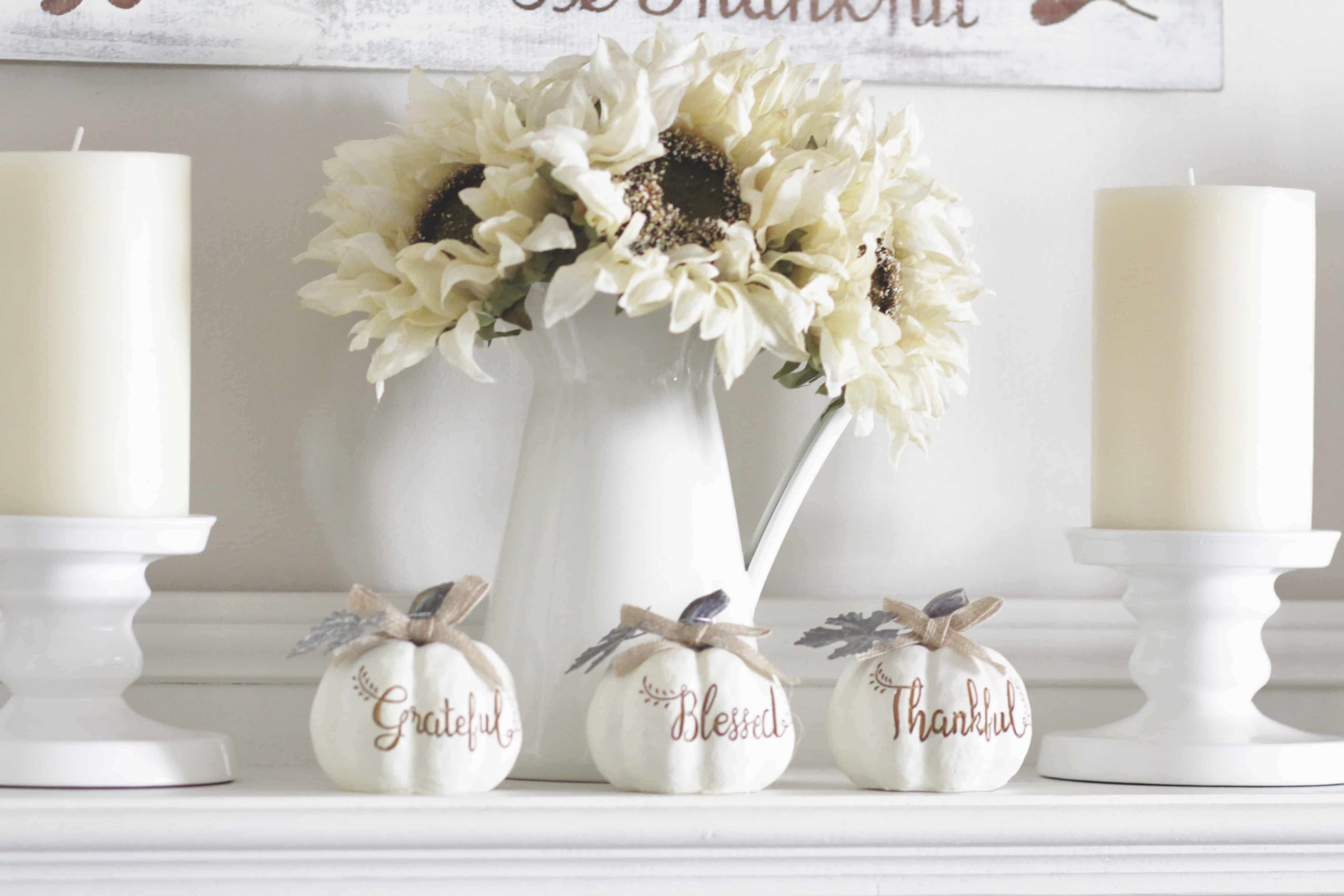 A closeup of grateful, thankful, blessed signed pumpkins on a mantel.