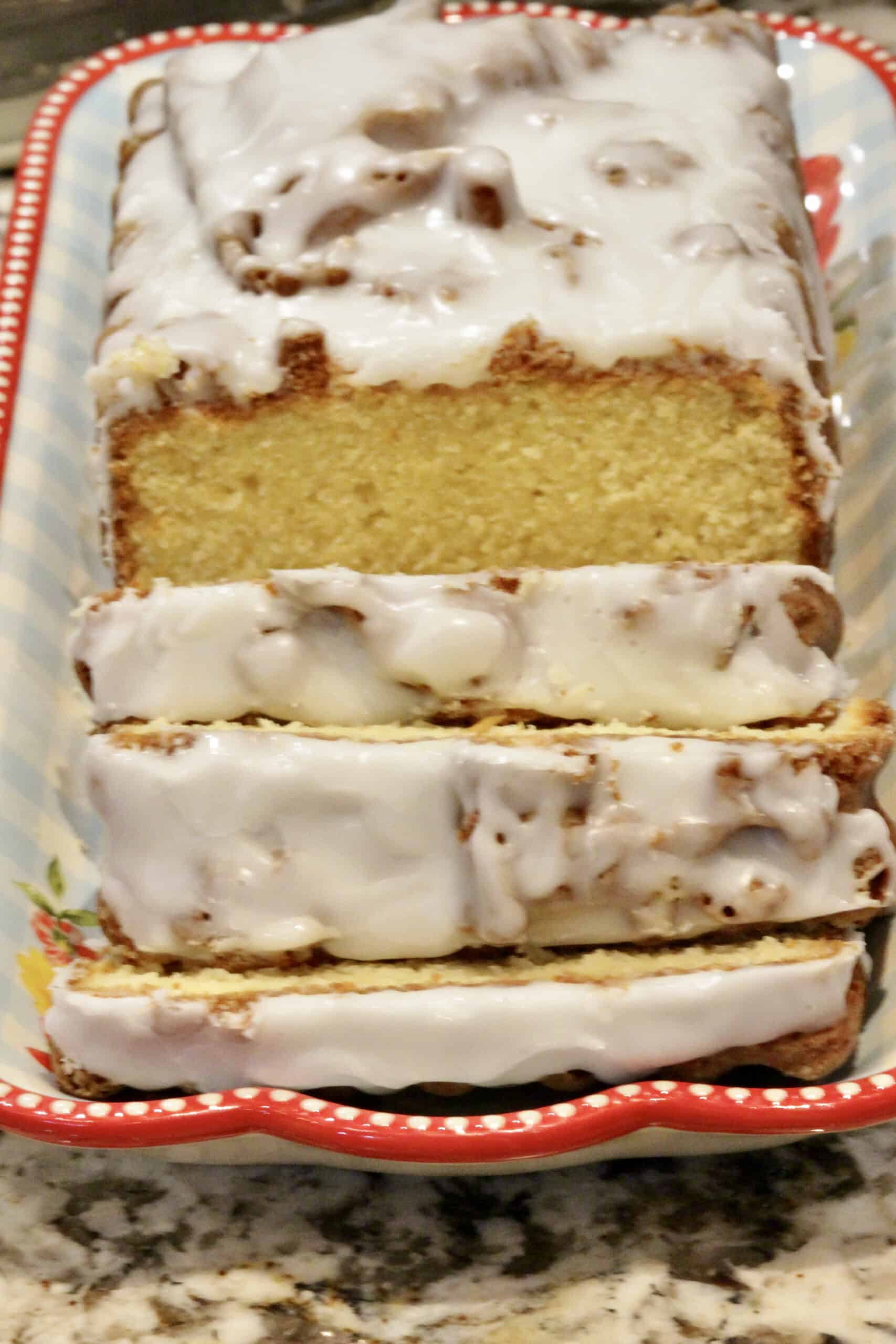 A sliced eggnog loaf cake on a platter.