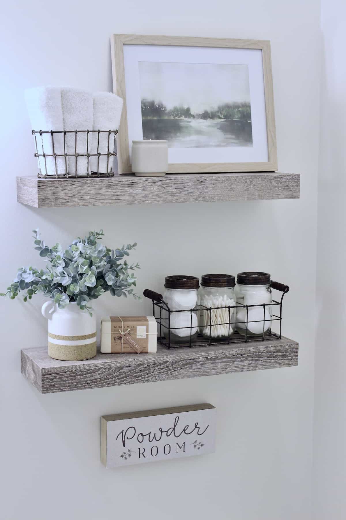 Two decorated shelves with a sign beneath them.