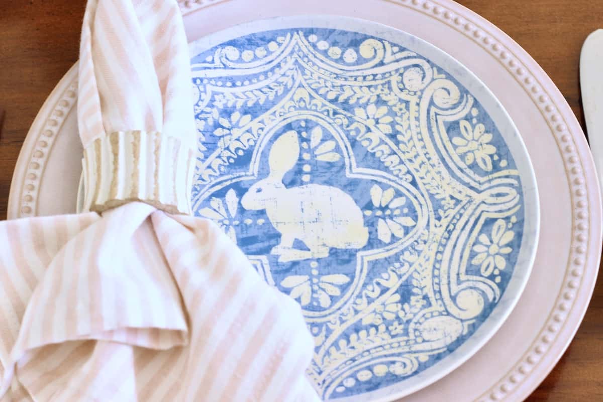 A bunny salad plate on a dinner plate with a striped napkin.