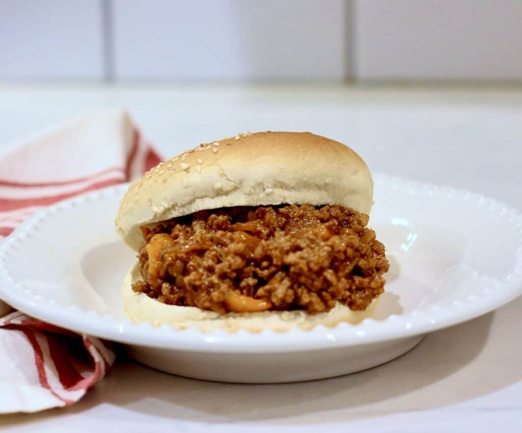 Sloppy Joe on plate with a red striped napkin.